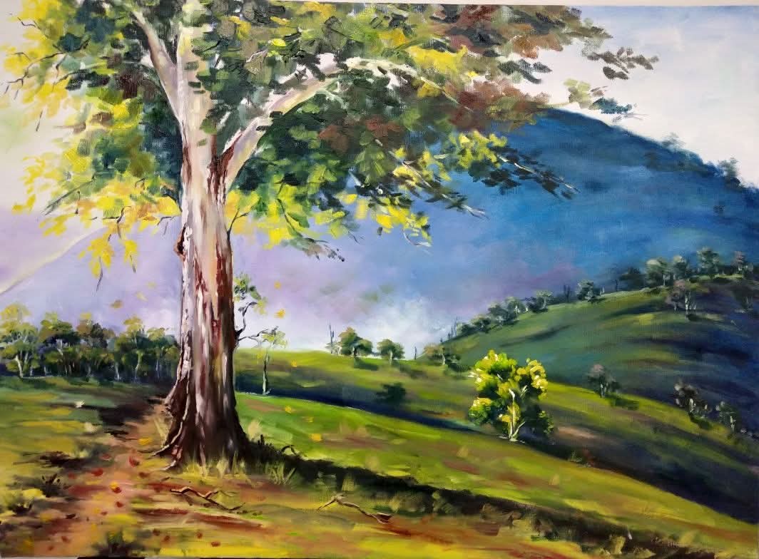 Painting of a sunlit tree overlooking a green valley and blue mountains